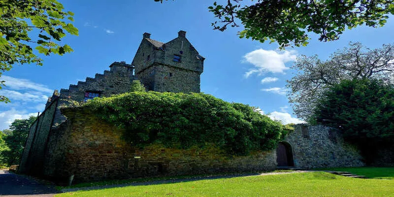 A massive stone fortress overlooks the deep blue sea