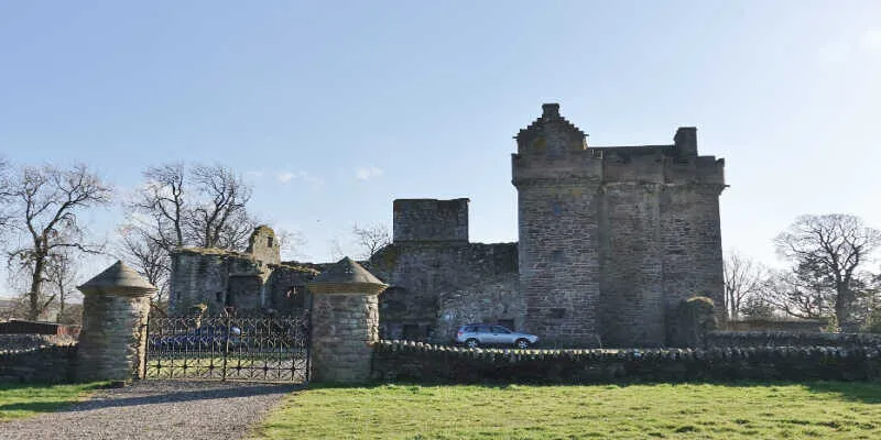 Green lawns surround the historic stone ruins